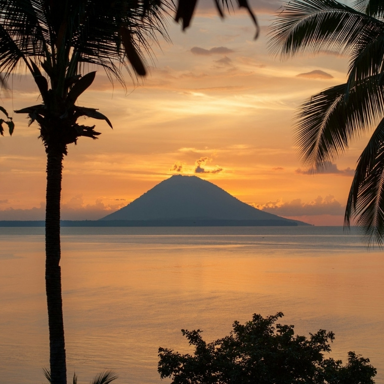 Coucher de soleil sur l'île de Siladen avec vue sur le volcan Manado Tua en Indonésie.