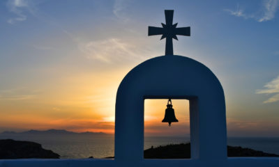Chapelle blanche avec cloche en silhouette au coucher du soleil à Antiparos dans les Cyclades