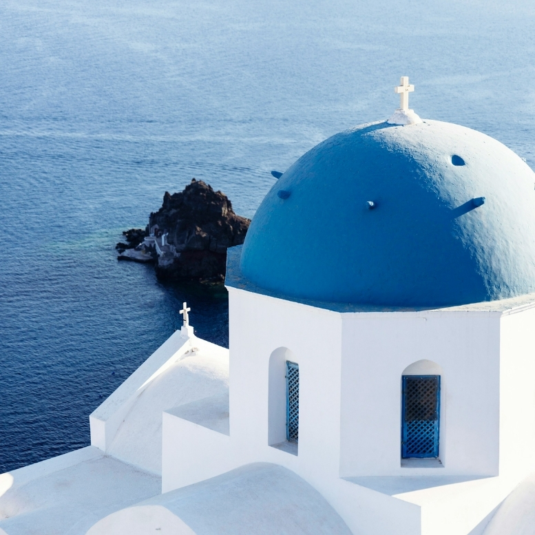 Dôme bleu suspendu au-dessus de la caldeira de Santorin, face à l’immensité de la mer Égée – un voyage sur mesure en Grèce entre villages blanchis à la chaux, panoramas volcaniques et lumière incomparable des Cyclades – Horizons Nouveaux